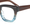 Close-up of a pair of eyeglasses with a brown frame and blue-tinted lenses on a white background.