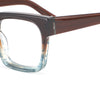 Close-up of a pair of eyeglasses with a brown frame and clear lenses on a white background.