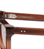 Close-up of brown sunglasses with 'LOONETTES' branding on a white background
